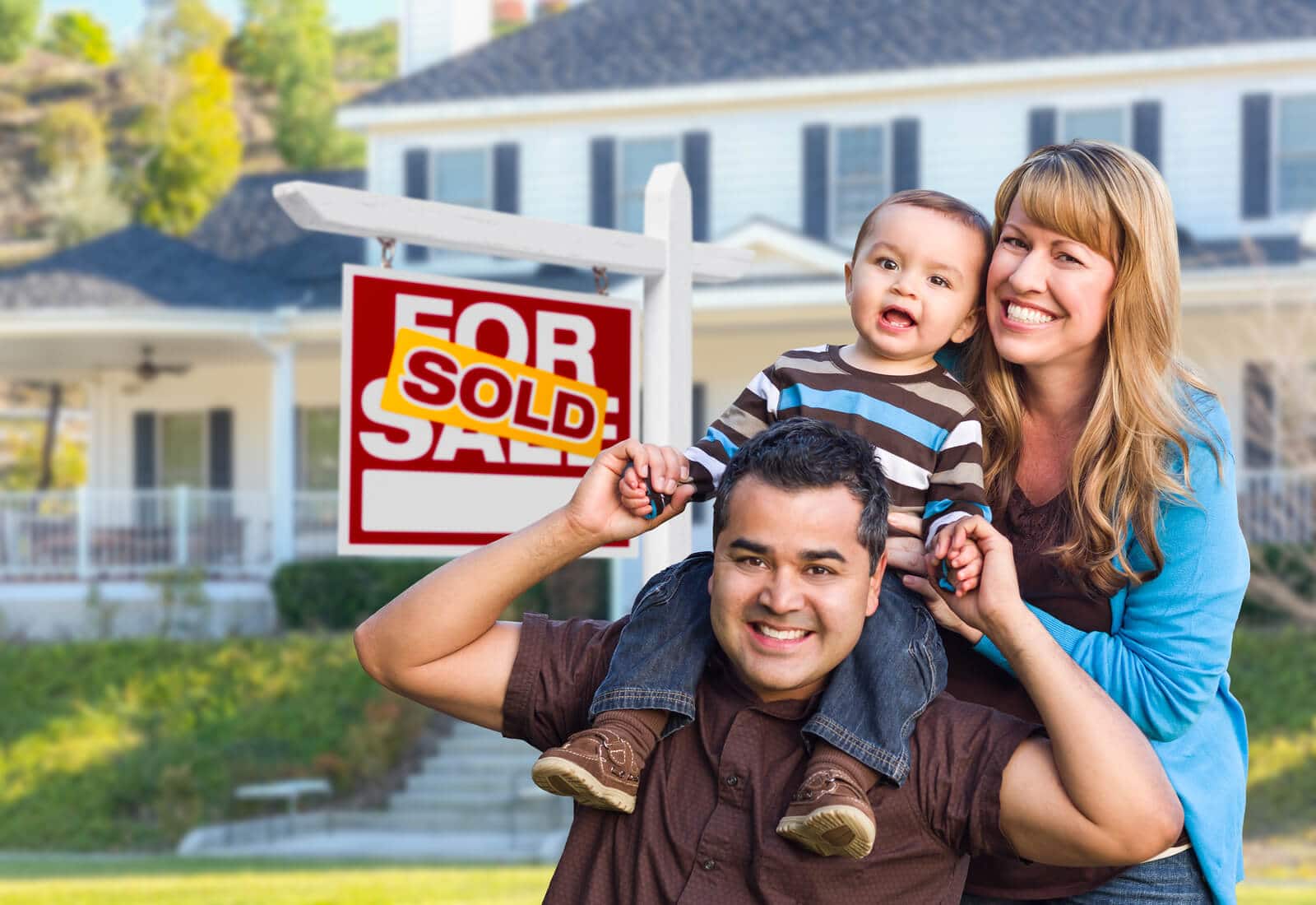 a family standing in front of their newly purchased home.