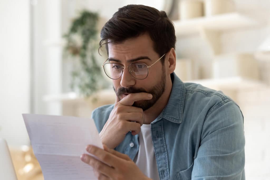 frustrated man reading bad news