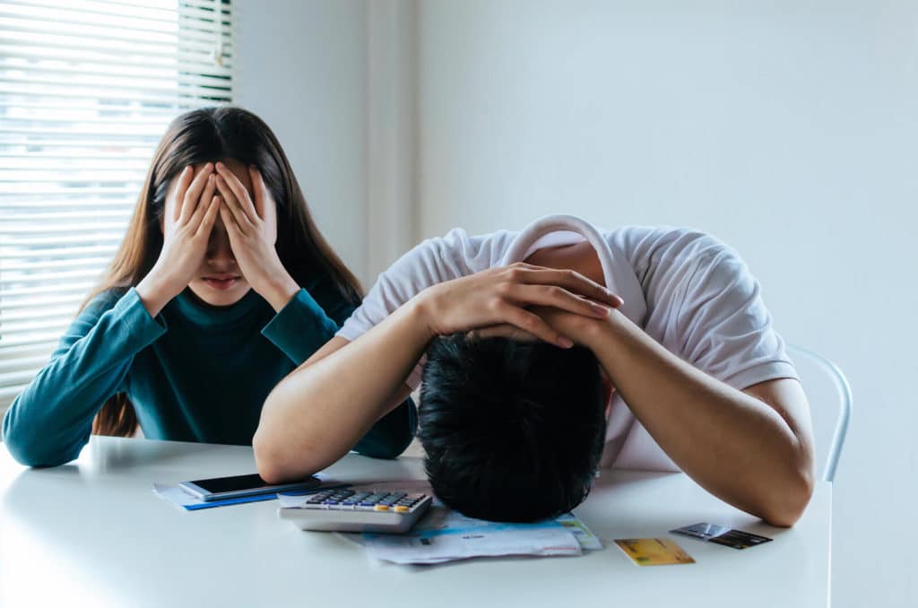 stressed couple trying to figure out their finances