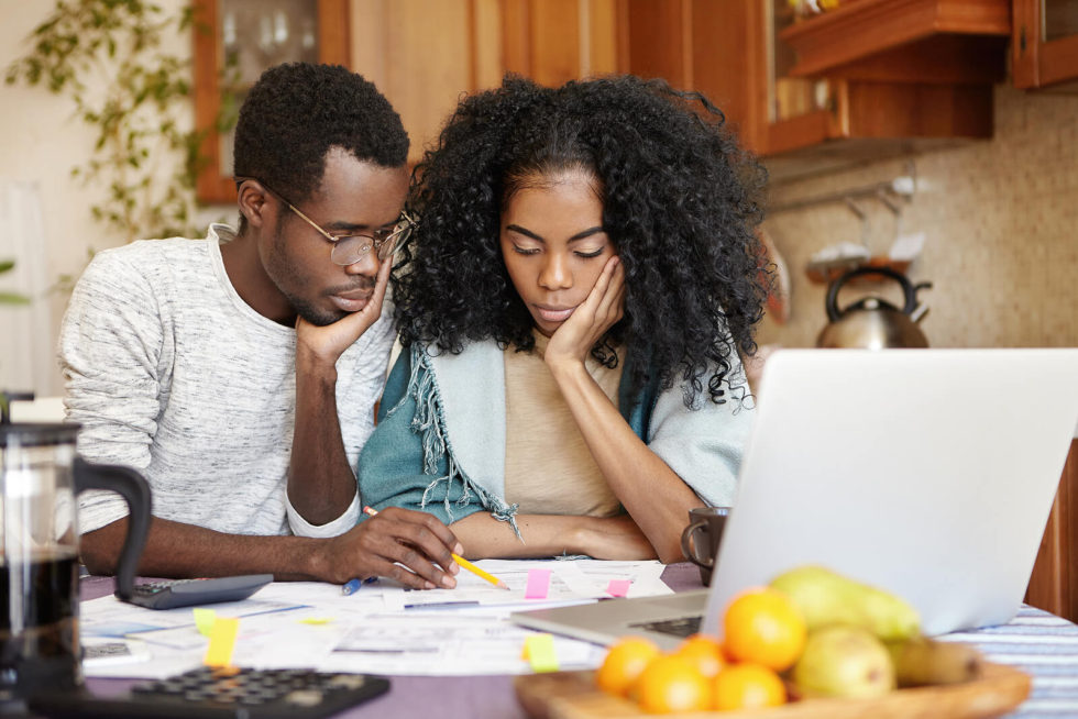 upset young couple with financial documents