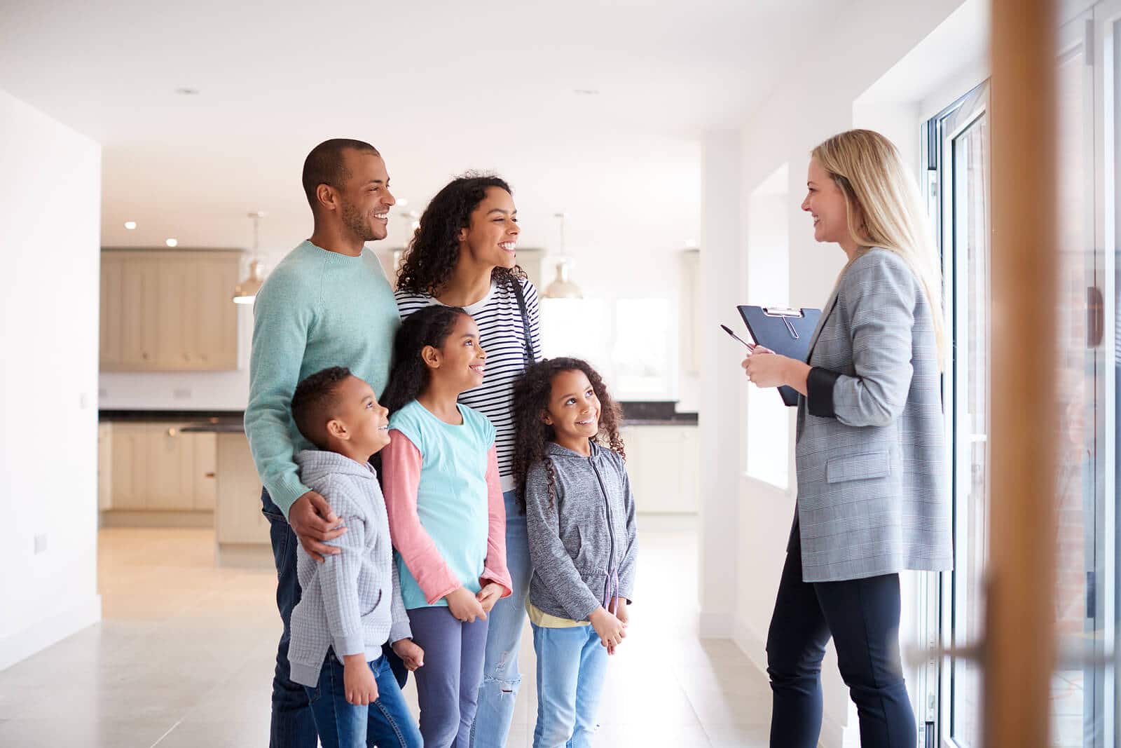 realtor showing a house to a family