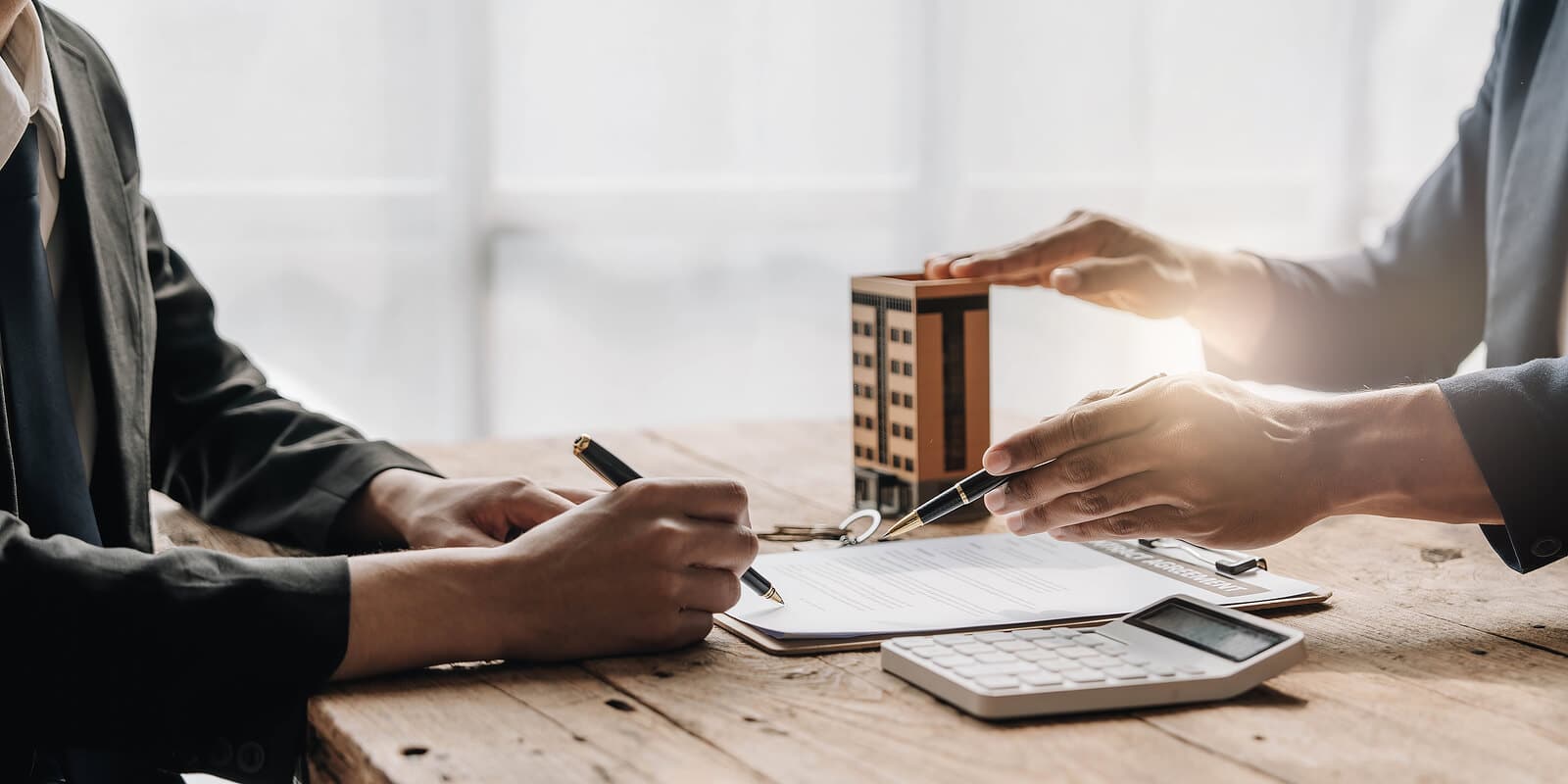 Realtor and buyer reviewing a contract